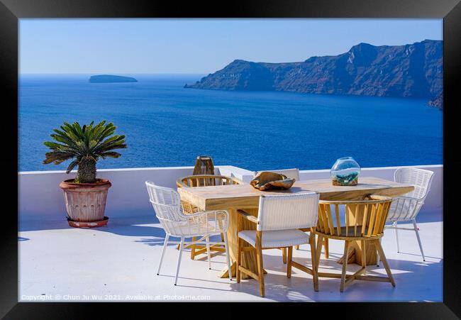 Outdoor seats facing Aegean Sea in Oia, Santorini, Greece Framed Print by Chun Ju Wu