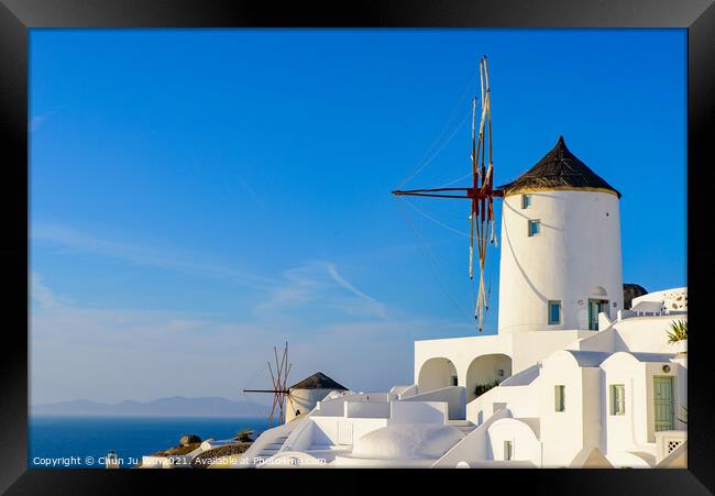 Windmill and traditional white buildings facing Aegean Sea in Oia, Santorini, Greece Framed Print by Chun Ju Wu