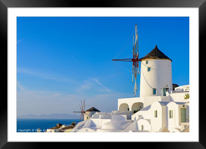 Windmill and traditional white buildings facing Aegean Sea in Oia, Santorini, Greece Framed Mounted Print by Chun Ju Wu