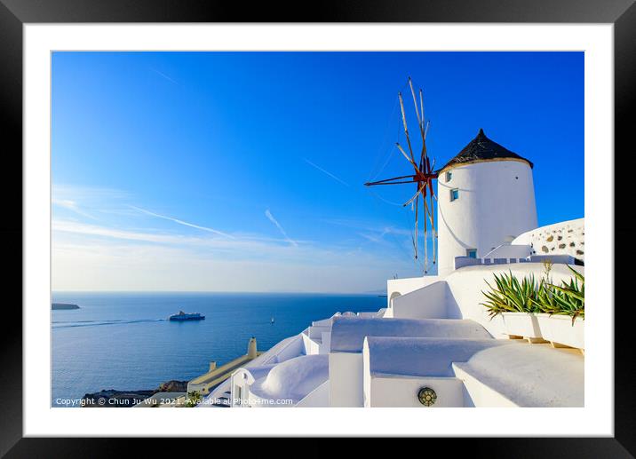 Windmill and traditional white buildings facing Aegean Sea in Oia, Santorini, Greece Framed Mounted Print by Chun Ju Wu