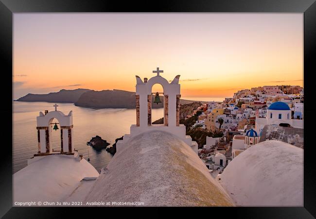 Blue domed churches and bell tower facing Aegean Sea with warm sunset light in Oia, Santorini, Greece Framed Print by Chun Ju Wu