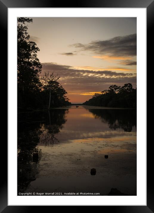 A sunset over a body of water Framed Mounted Print by Roger Worrall