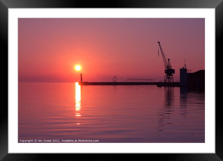 Port crane at sunset Framed Mounted Print by Nic Croad