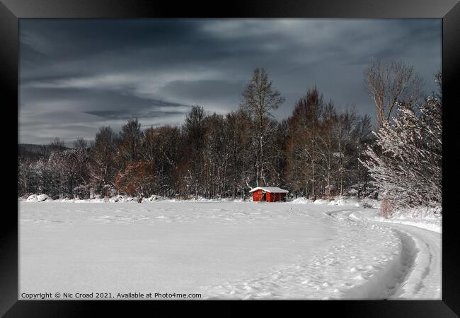 Winter scene with a single red barn Framed Print by Nic Croad