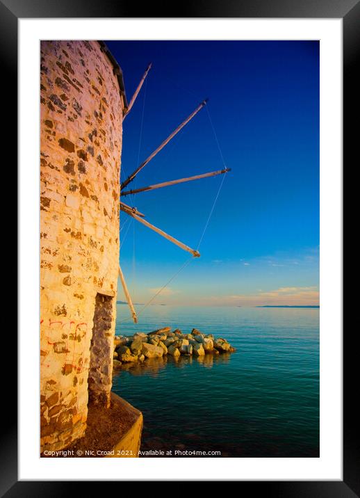 Greek windmill on the beach Framed Mounted Print by Nic Croad