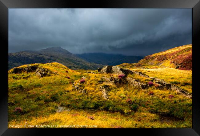 Summer light on the Lakeland fells Framed Print by John Henderson