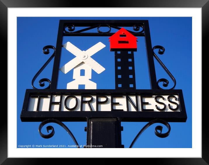 Thorpeness Village Sign showing the Windmill and House in the Cl Framed Mounted Print by Mark Sunderland