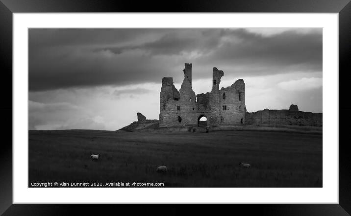 Dunstanburgh Under a cloud Framed Mounted Print by Alan Dunnett