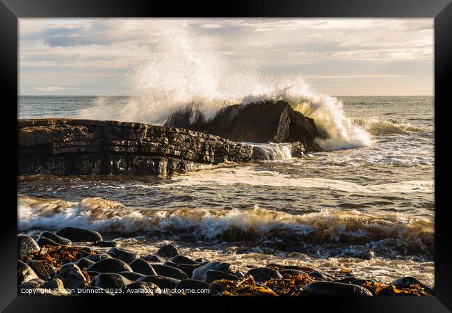 Dunstanburgh big splash at Greymare Rock Framed Print by Alan Dunnett