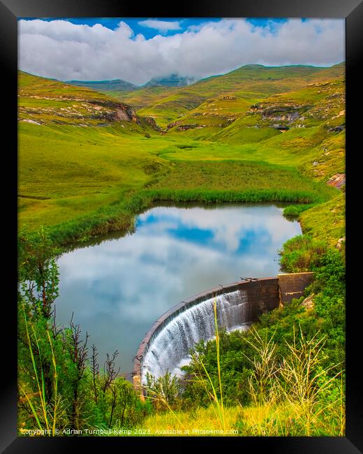 View over Langtoon Dam nestled in a valley in the Golden Gate Highlands National Park beneath the distant Maluti mountains, Free State, South Africa.  Framed Print by Adrian Turnbull-Kemp