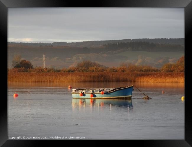 Blue boat on the Exe Estuary in early morning winter sunlight Framed Print by Joan Rosie