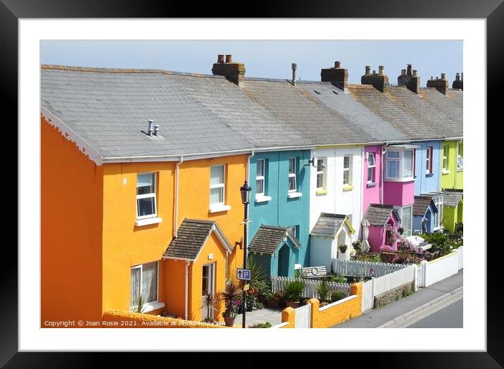 Row of brightly coloured houses in a street in Westward Ho! Framed Mounted Print by Joan Rosie