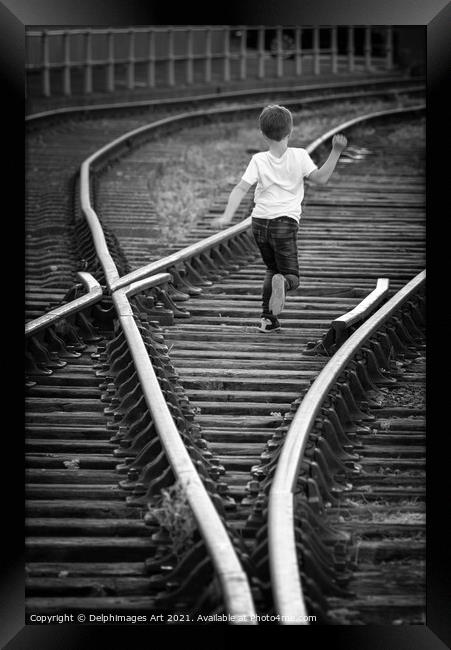 Boy running on old railway tracks in Bristol Framed Print by Delphimages Art