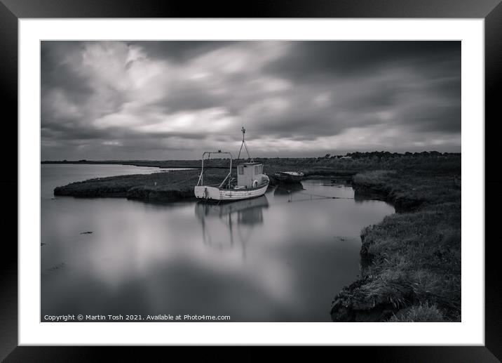 Patience. Fishing boat in salt marsh Framed Mounted Print by Martin Tosh