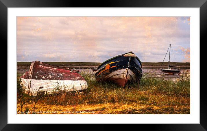 Abandoned boats on the shore of Lindisfarne, Holy Island, Northumberland, England Framed Mounted Print by Linda Webb