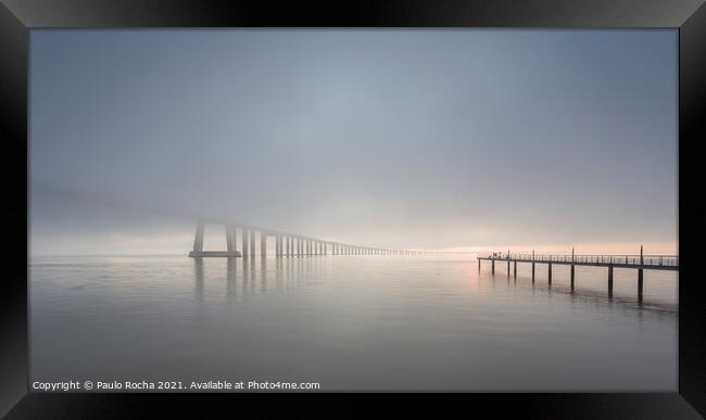 Long bridge over tagus river in Lisbon at sunrise with fog Framed Print by Paulo Rocha
