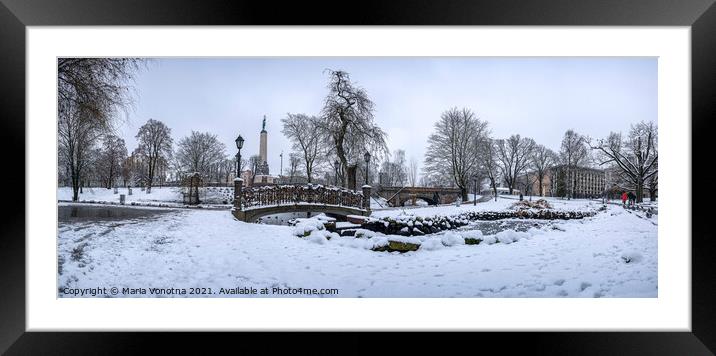 Snowy park with footbridge in winter Framed Mounted Print by Maria Vonotna
