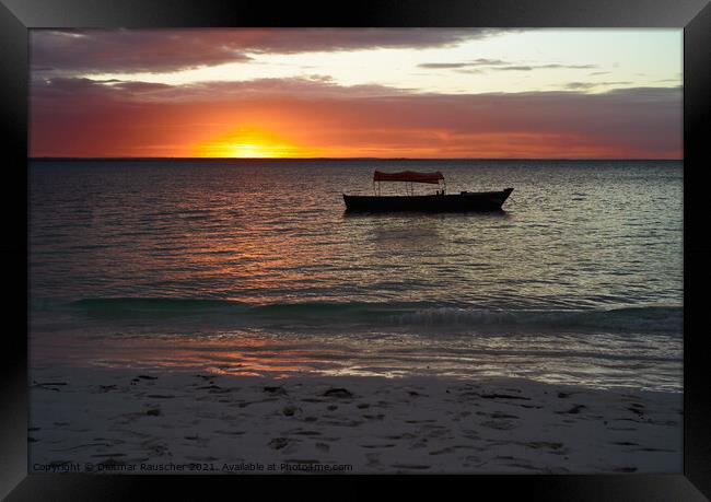 Sunset behind a boat on a body of water Framed Print by Dietmar Rauscher