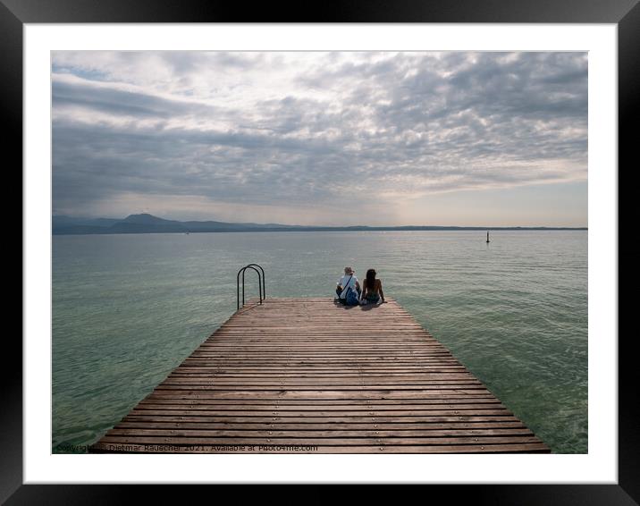 Tourists Sitting on jetty on Lake Garda in Sirmione Framed Mounted Print by Dietmar Rauscher