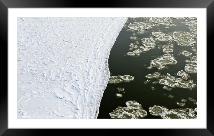 River bank covered with snow and floating ice Framed Mounted Print by Paulina Sator