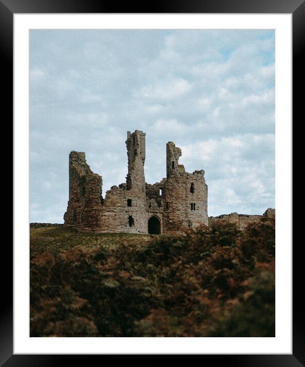 Dunstanburgh Castle in Winter Framed Mounted Print by Dan Beegan