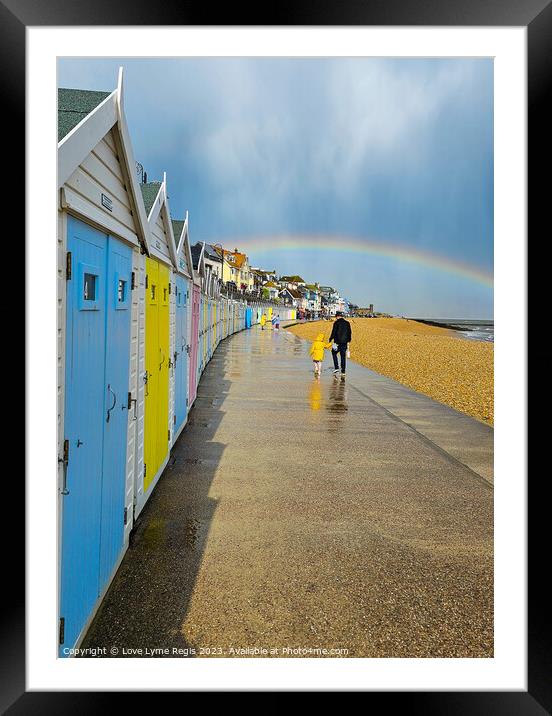 Pastel coloured beach huts Lyme Regis with a rainbow Framed Mounted Print by Love Lyme Regis