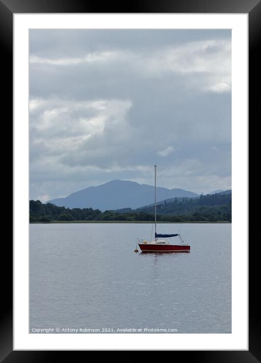 Little red sail boat moored on Loch Insh Framed Mounted Print by Antony Robinson