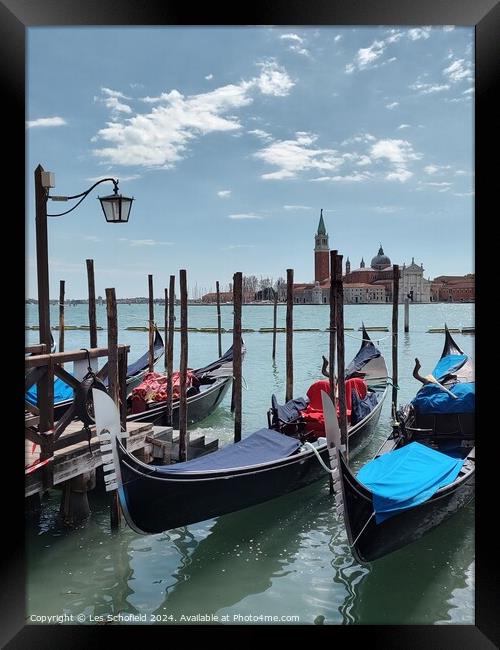 Gondolas on the Venice canal  Framed Print by Les Schofield