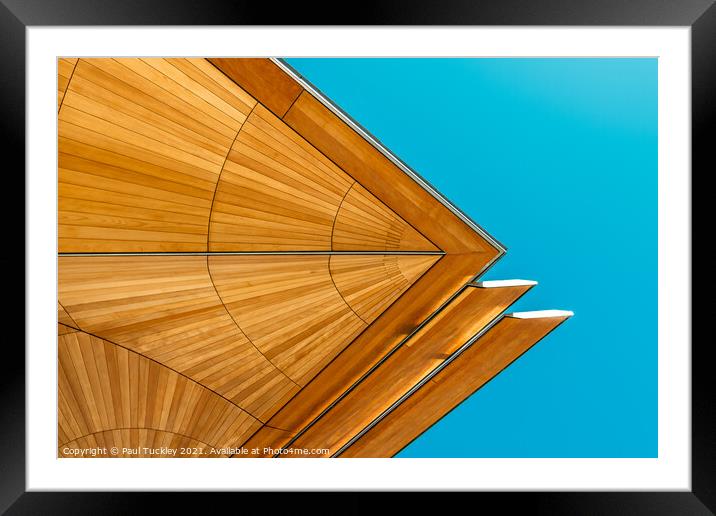 Abstract view of roof structure against blue sky.  Framed Mounted Print by Paul Tuckley