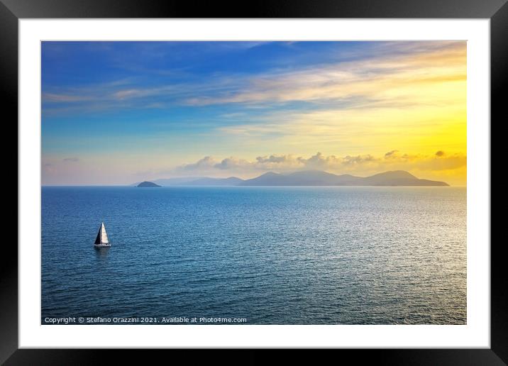 Elba island sunset view and sail boat Framed Mounted Print by Stefano Orazzini