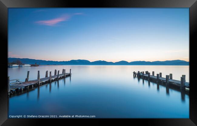 Two Wooden piers on a lake Framed Print by Stefano Orazzini