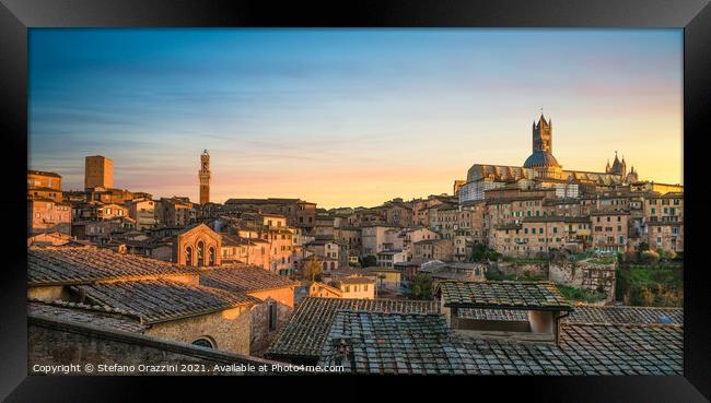Siena panoramic skyline at sunset. Mangia tower and Duomo Framed Print by Stefano Orazzini