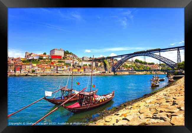 Oporto skyline, Douro river, traditional boats and iron bridge. Framed Print by Stefano Orazzini