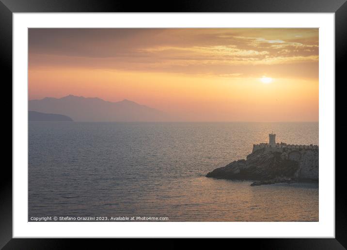 Lighthouse of Piombino at sunset and Elba island. Framed Mounted Print by Stefano Orazzini
