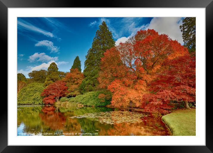 A body of water surrounded by trees in Autumn Colo Framed Mounted Print by John Gilham