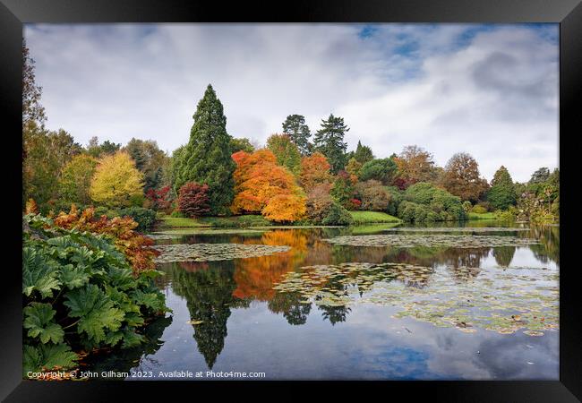 Autumn colours beyond the lake Framed Print by John Gilham