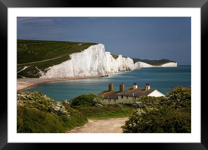 The Seven Sisters cliffs and the Coastguards Cottages at Cuckmere Haven near Eastbourne in East Sussex UK Framed Mounted Print by John Gilham