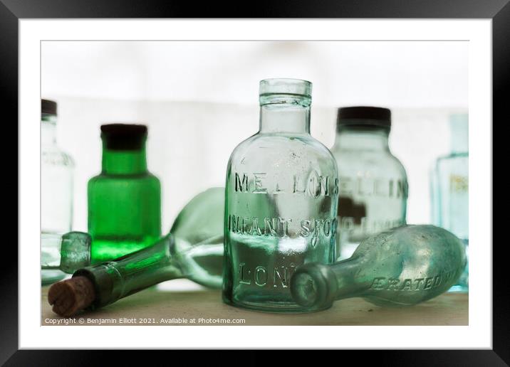 Old bottles on a shelf Framed Mounted Print by Benjamin Elliott
