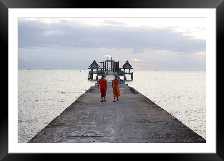 Thai monks on the bridge or Pier , which leads to the never finished and abandoned Thai temple right on the Gulf in Thailand in the province of Chonburi Framed Mounted Print by Wilfried Strang