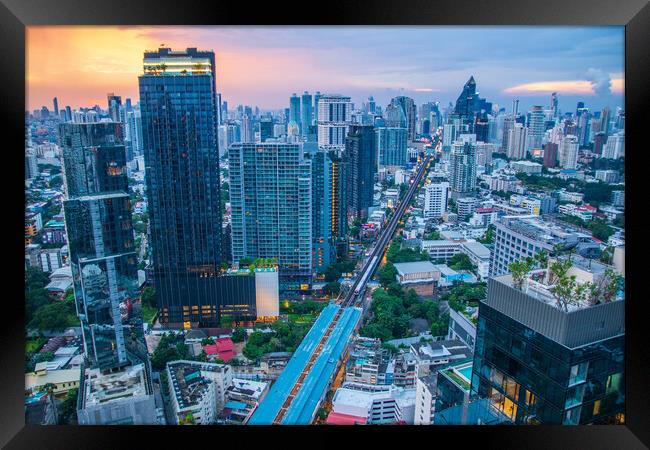 The Cityscape, the Railway of the Skytrain and the skyscraper of Bangkok in Thailand Southeast Asia at the Evening Framed Print by Wilfried Strang