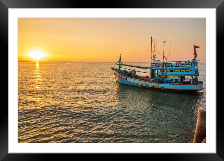  A fishing boat at a pier in the early evening during sunset time Framed Mounted Print by Wilfried Strang
