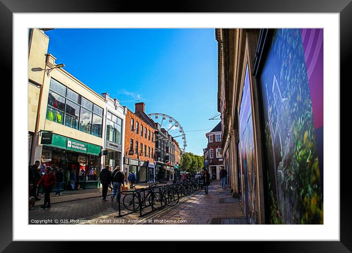 Bikes Buildings and a Wheel Framed Mounted Print by GJS Photography Artist