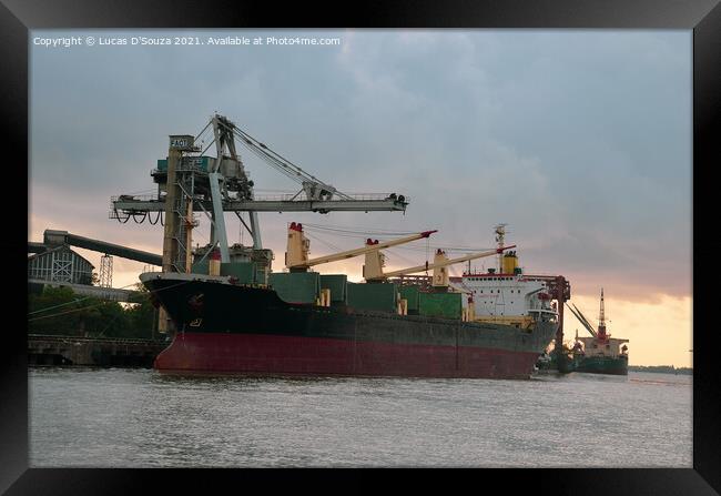 A ship at a harbor at sunset with heavy cranes in the background Framed Print by Lucas D'Souza