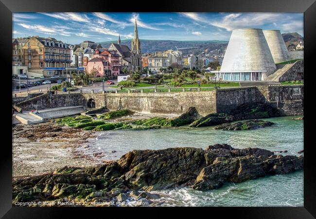 Conical Towers Rise Over Serene Coastal Town Framed Print by Roger Mechan