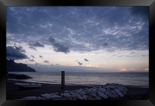 Beach with cloudy sky and a small boat  Framed Print by Adelaide Lin