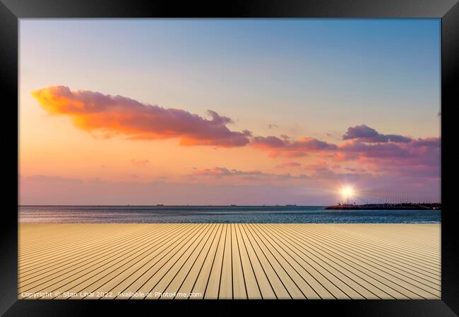 Sunset over the beach Framed Print by Stan Lihai