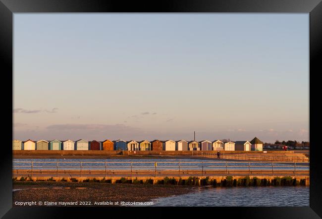Beach huts at Brightlingsea during golden hour Framed Print by Elaine Hayward