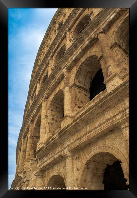 Coliseum looms above Framed Print by Paul Pepper