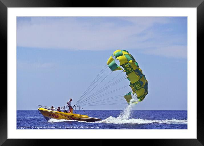 Parasailing boat Framed Mounted Print by Raymond Evans