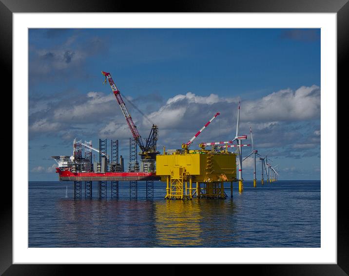 Offshore jackup installing turbine blades Framed Mounted Print by Russell Finney